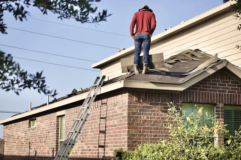 Professional roofer working on a residential roof in Pleasant Point